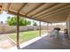 Backyard with a covered patio, outdoor dining table, and grill at 903 W Shawnee Dr, Chandler, AZ 85225