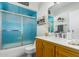 Well-lit bathroom with a glass-enclosed shower, single sink vanity, and stylish decor at 903 W Shawnee Dr, Chandler, AZ 85225