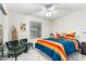 Cozy bedroom features a bright color scheme, plush carpet, a ceiling fan, and comfortable seating area at 903 W Shawnee Dr, Chandler, AZ 85225
