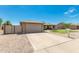 Single-story home with a well-kept lawn, gravel landscaping, and an attached garage at 903 W Shawnee Dr, Chandler, AZ 85225