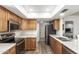 Spacious kitchen with stainless steel appliances, wood cabinets, and modern countertops at 903 W Shawnee Dr, Chandler, AZ 85225