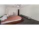 Spacious bedroom with modern ceiling fan and dark hardwood floors at 9415 W Eaton Rd, Phoenix, AZ 85037