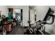 Bedroom featuring an exercise bike, mirrored closet doors, and gray colored walls at 9415 W Eaton Rd, Phoenix, AZ 85037