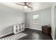 Bedroom with hardwood floors, ceiling fan, and natural light at 9415 W Eaton Rd, Phoenix, AZ 85037