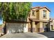 Two story home with a two-car garage, desert landscaping, and a tiled roof at 9415 W Eaton Rd, Phoenix, AZ 85037