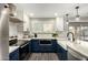 Modern kitchen boasts white and blue cabinets, stainless steel appliances, and an undermount sink at 9415 W Eaton Rd, Phoenix, AZ 85037