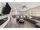 Spacious living room with a fireplace, gray sectional, and wood-look floors at 9415 W Eaton Rd, Phoenix, AZ 85037