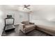 Upstairs living room with neutral toned sofa, treadmill, and a bright ceiling fan at 9415 W Eaton Rd, Phoenix, AZ 85037