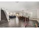 Spacious living room featuring hardwood floors, stairs to the second floor, and a view into the modern kitchen at 9415 W Eaton Rd, Phoenix, AZ 85037