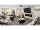 Spacious living room with a fireplace, gray sectional, and wood-look floors at 9415 W Eaton Rd, Phoenix, AZ 85037