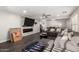 Spacious living room with a fireplace, gray sectional, and wood-look floors at 9415 W Eaton Rd, Phoenix, AZ 85037