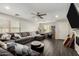 Spacious living room with a fireplace, gray sectional, and wood-look floors at 9415 W Eaton Rd, Phoenix, AZ 85037