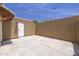 Enclosed backyard featuring a concrete patio and stucco walls for privacy with clear blue skies above at 948 S Alma School Rd # 1, Mesa, AZ 85210