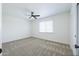 Spacious bedroom with neutral carpet, a ceiling fan, and a window with natural light at 948 S Alma School Rd # 1, Mesa, AZ 85210