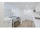 Well-lit kitchen with stainless steel oven, white cabinets, and quartz countertops at 948 S Alma School Rd # 1, Mesa, AZ 85210