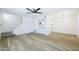 Open-concept living room with wood floors and a staircase, flowing into the bright kitchen area at 948 S Alma School Rd # 1, Mesa, AZ 85210