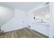 Bright open-concept living area offering vinyl floors, a staircase, and an opening to the kitchen at 948 S Alma School Rd # 1, Mesa, AZ 85210