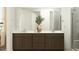 Modern bathroom with double vanity, sleek cabinetry, and a glass-enclosed shower at 9522 W Avalon Dr, Phoenix, AZ 85037