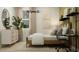 Serene bedroom with neutral tones, a modern light fixture, and a functional desk area at 9522 W Avalon Dr, Phoenix, AZ 85037