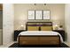 Stylish bedroom showcasing black-framed art above a rattan headboard bed and black nightstands at 9522 W Avalon Dr, Phoenix, AZ 85037