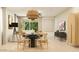 Open-concept dining area featuring a modern light fixture, stylish seating, and contemporary decor at 9522 W Avalon Dr, Phoenix, AZ 85037