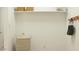 Organized mud room with ample storage, including shelves, hooks, and a decorative laundry basket at 9522 W Avalon Dr, Phoenix, AZ 85037