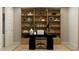 Stylish home office featuring custom built-in shelving, a sleek desk, and ample workspace at 9522 W Avalon Dr, Phoenix, AZ 85037