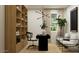 Modern office with a bookshelf, a black desk, and bright, airy seating at 9522 W Avalon Dr, Phoenix, AZ 85037