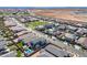 An aerial shot of a neighborhood featuring houses with pools, green spaces, and desert landscapes at 9645 E Ripple Dr, Mesa, AZ 85212