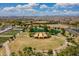 Wide aerial of community featuring a park with lake, fields, and community gardens at 9645 E Ripple Dr, Mesa, AZ 85212
