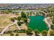 Stunning aerial view of community lake, showcasing lush landscaping, walking paths, and nearby homes at 9645 E Ripple Dr, Mesa, AZ 85212