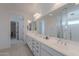 Clean bathroom with a double sink vanity, large mirror, and well lit at 9645 E Ripple Dr, Mesa, AZ 85212