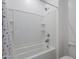 A clean and bright bathroom shower with tiled walls, shower head, and built in shelf at 9645 E Ripple Dr, Mesa, AZ 85212