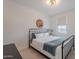 Clean bedroom with a modern black metal bed frame and accent wall decor at 9645 E Ripple Dr, Mesa, AZ 85212