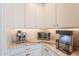 A well-organized butler's pantry features white cabinets, granite countertops, and modern appliances at 9645 E Ripple Dr, Mesa, AZ 85212