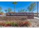 The 'Mark Community Center' sign at the entrance with manicured landscaping and vibrant flowers at 9645 E Ripple Dr, Mesa, AZ 85212