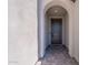 Inviting entryway featuring an arched alcove leading to a modern front door at 9645 E Ripple Dr, Mesa, AZ 85212