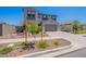 A charming two-story home with desert landscaping, a two-car garage, and shuttered windows at 9645 E Ripple Dr, Mesa, AZ 85212
