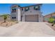 Traditional two-story home showcasing neutral stucco, two-car garage, shutters, and desert landscaping at 9645 E Ripple Dr, Mesa, AZ 85212