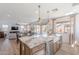Spacious open-concept kitchen with a large island, farmhouse sink, and view to the living area at 9645 E Ripple Dr, Mesa, AZ 85212