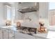 Close-up of the kitchen showcasing modern gas cooktop, pot filler, and white cabinetry with granite countertops at 9645 E Ripple Dr, Mesa, AZ 85212