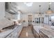 A spacious kitchen showcases white cabinets, stainless steel appliances, and a large granite countertop island at 9645 E Ripple Dr, Mesa, AZ 85212