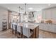 Bright kitchen with large island, seating, stainless steel appliances, and modern lighting fixtures at 9645 E Ripple Dr, Mesa, AZ 85212