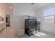Well lit laundry room with front load washer and dryer and built in shelves at 9645 E Ripple Dr, Mesa, AZ 85212