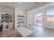 Bright, open living area with light wood floors, a display cabinet, and sliding glass doors to the patio at 9645 E Ripple Dr, Mesa, AZ 85212