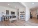Bright living room with light wood floors, recessed lights, and a reading nook with bookshelves at 9645 E Ripple Dr, Mesa, AZ 85212