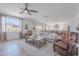 Bright, open living room with wood floors, comfortable seating, view of backyard, and access to the kitchen at 9645 E Ripple Dr, Mesa, AZ 85212