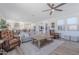 Spacious living room with ceiling fan, wood floors, comfortable seating, and view into kitchen at 9645 E Ripple Dr, Mesa, AZ 85212