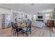 An open-concept living room and dining area with wood floors and lots of natural light at 9645 E Ripple Dr, Mesa, AZ 85212