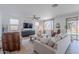 Bright living room with a ceiling fan, neutral tones, comfortable seating, and backyard view at 9645 E Ripple Dr, Mesa, AZ 85212